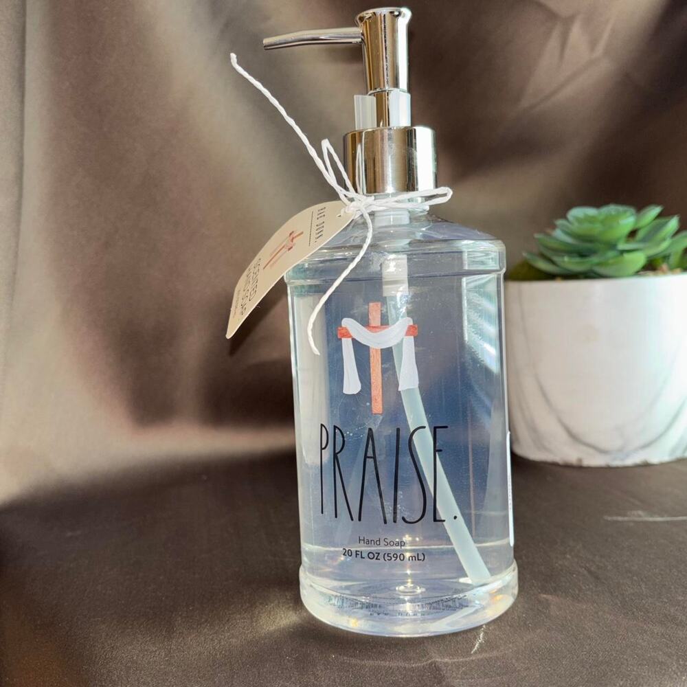 Rae Dunn White refillable soap dispenser with honey almond hand soap.'